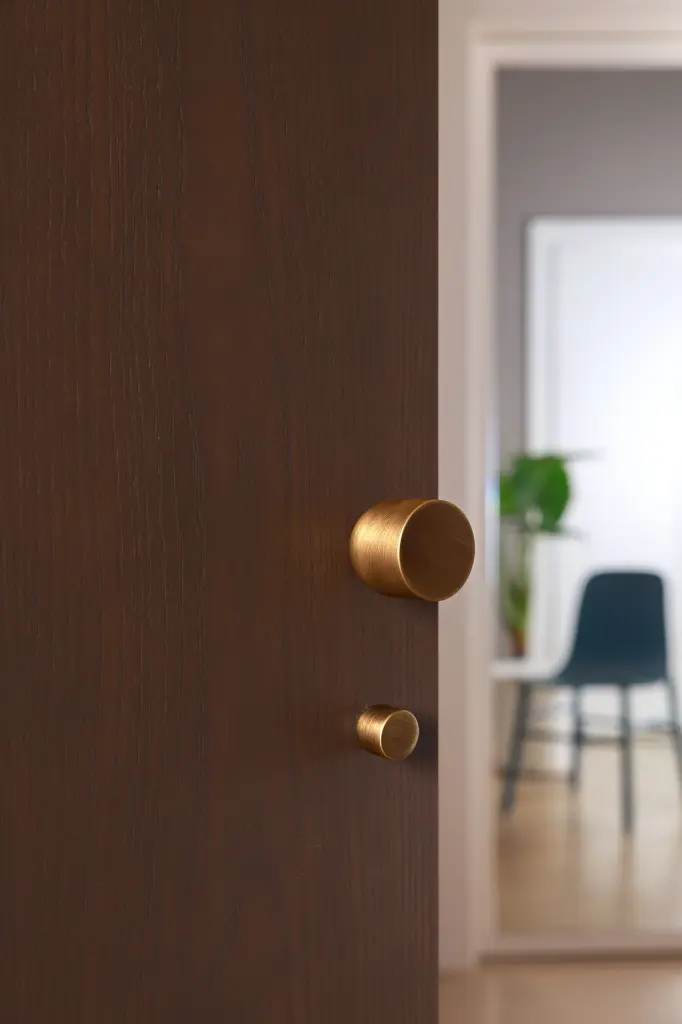 Wooden door Lui knob and Punto privacy set yesterday bronze finish.webp
